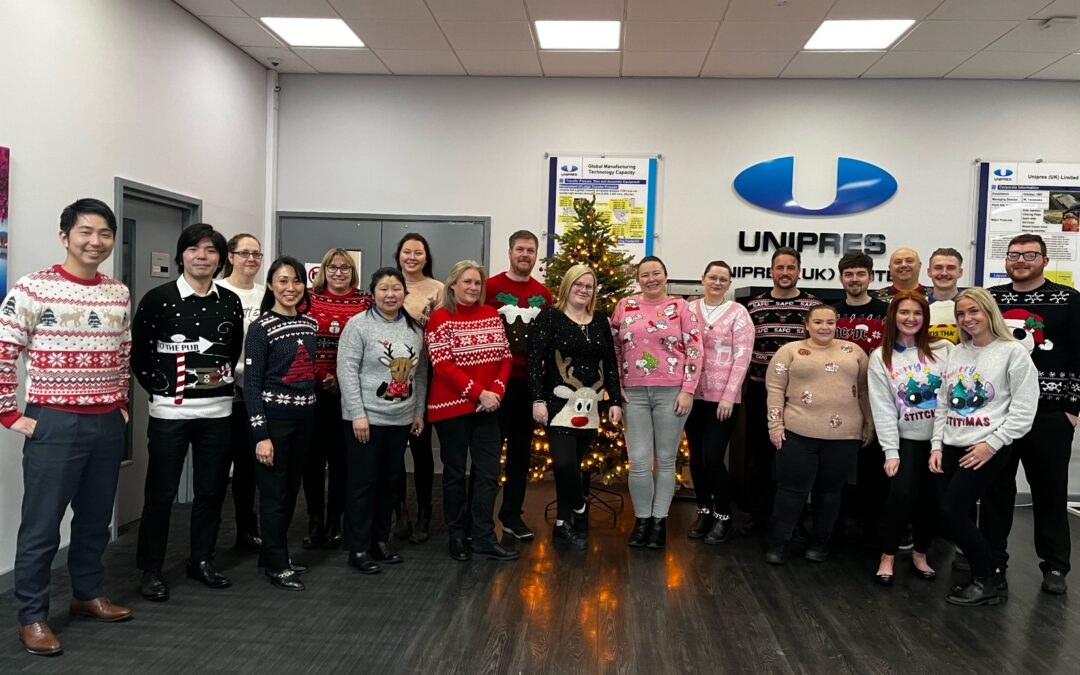 Unipres employees wearing Christmas jumpers